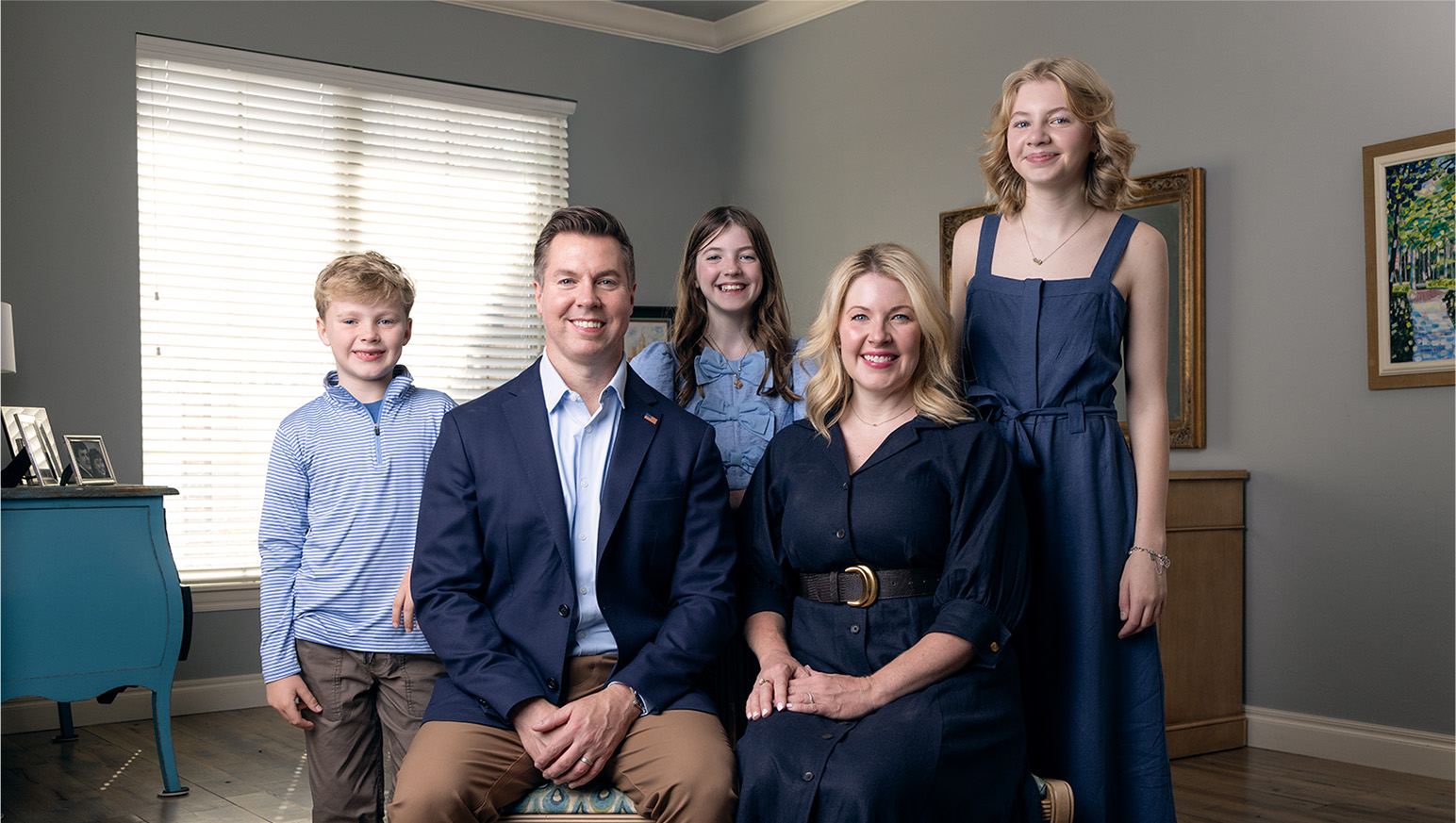 Adam Pugh, his wife, and their three children sitting inside
