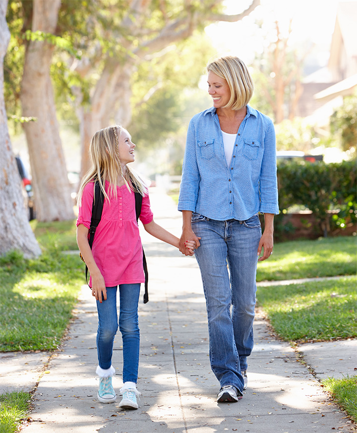 Mother walking her daughter to school